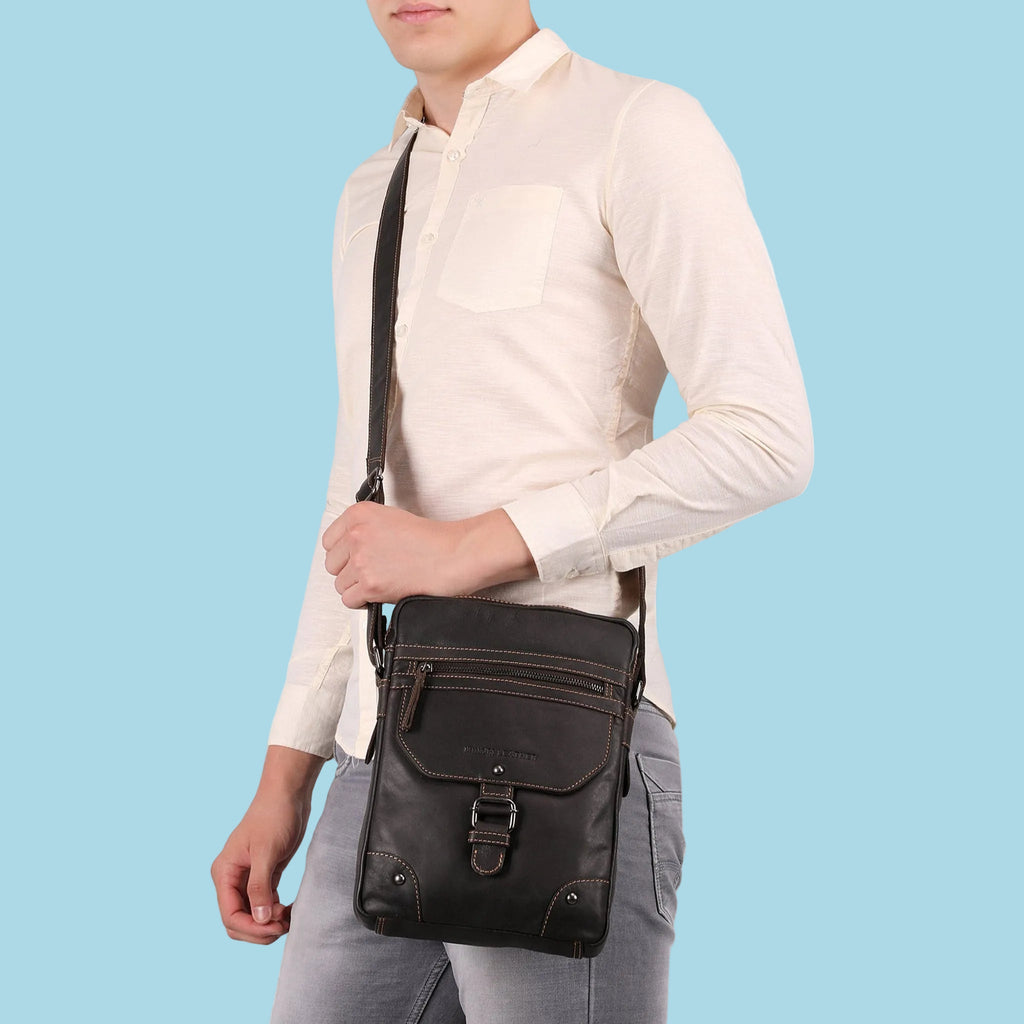 Minori Leather Denver unisex chestnut leather crossbody bag with adjustable strap and top zipper closure.