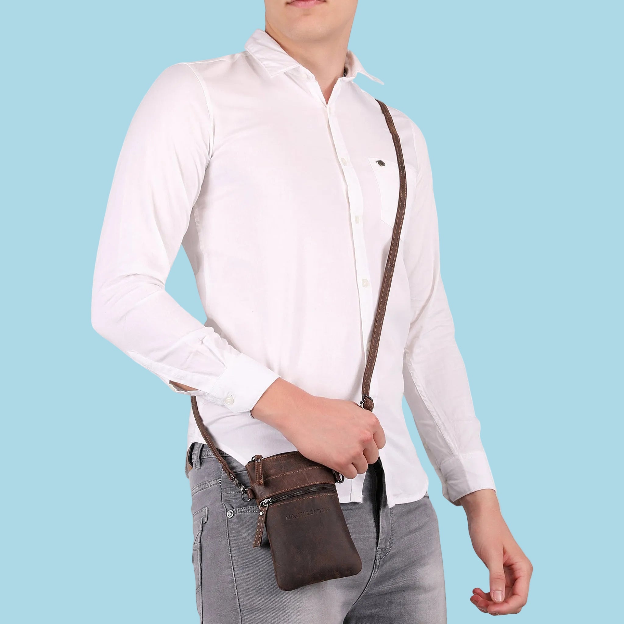 Brown Minori Leather Ashford sling bag for unisex use, featuring a sleek leather design with a shoulder strap and compact size.