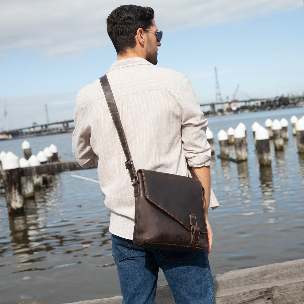 Minori Leather Noah crossbody satchel bag in chestnut leather with adjustable strap and gold-tone hardware.