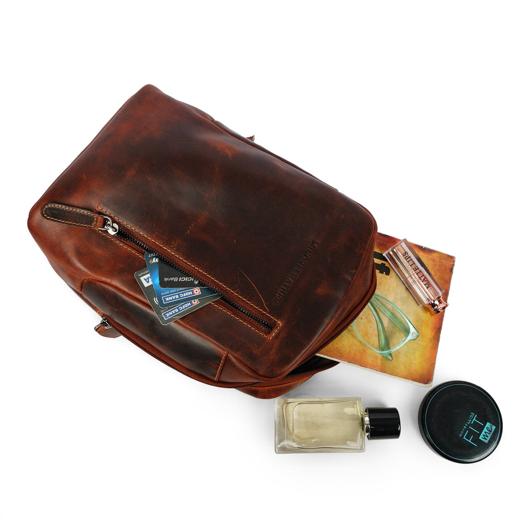 Minori Leather Luxe Leather Sling Chestnut crossbody bag with adjustable strap and sleek design, shown on a neutral background.