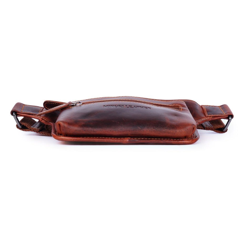 Unisex Osaka Leather Belt Bag in chestnut color with adjustable strap and Minori Leather branding, worn as a stylish fanny pack.