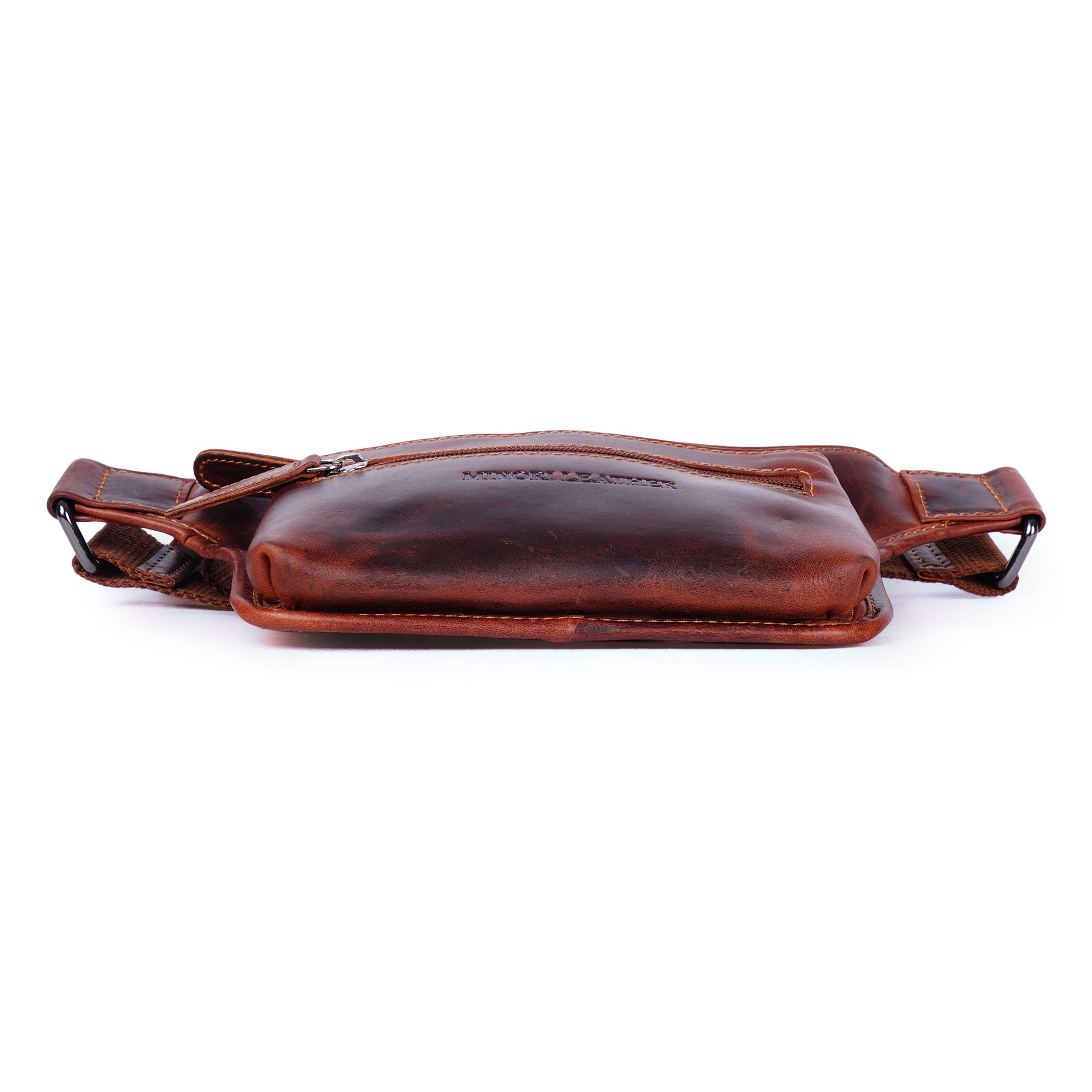 Unisex Osaka Leather Belt Bag in chestnut color with adjustable strap and Minori Leather branding, worn as a stylish fanny pack.
