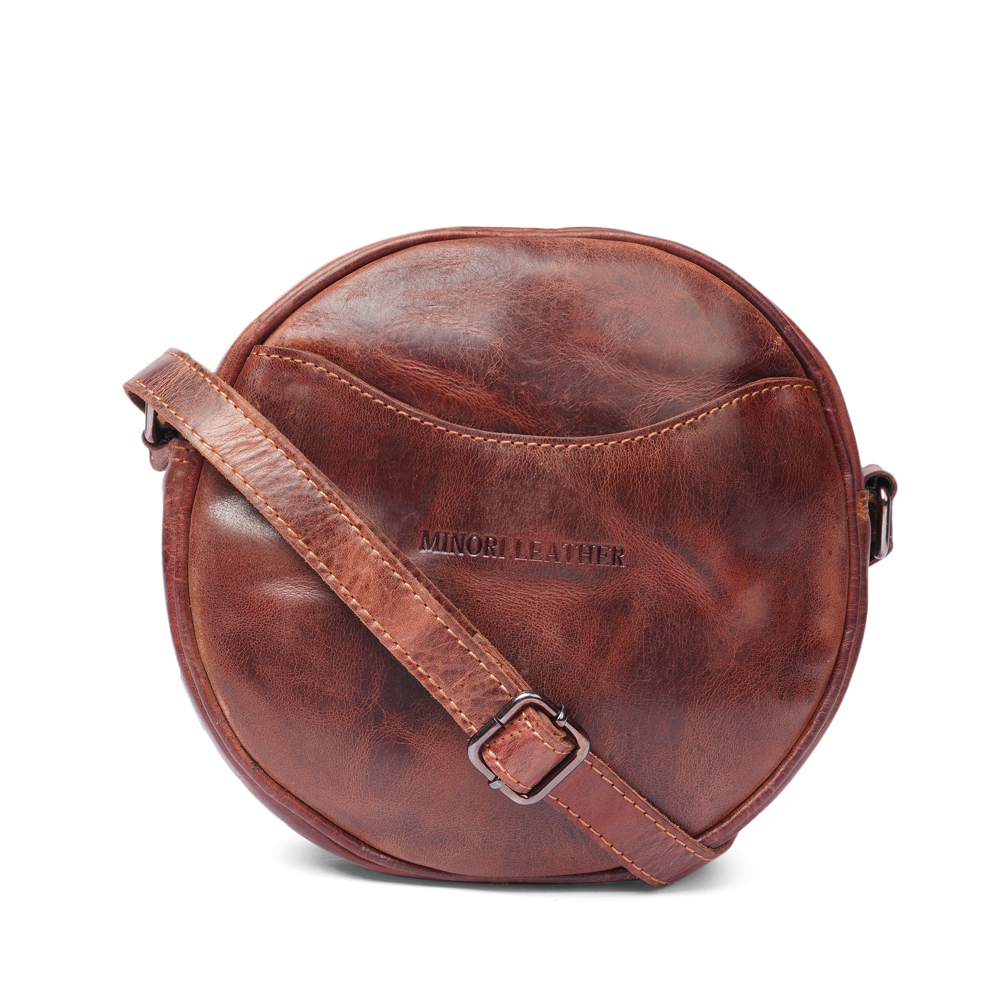 Minori Leather Luna leather round crossbody bag in chestnut and brown with hair-on brown accents, stylish women's accessory.