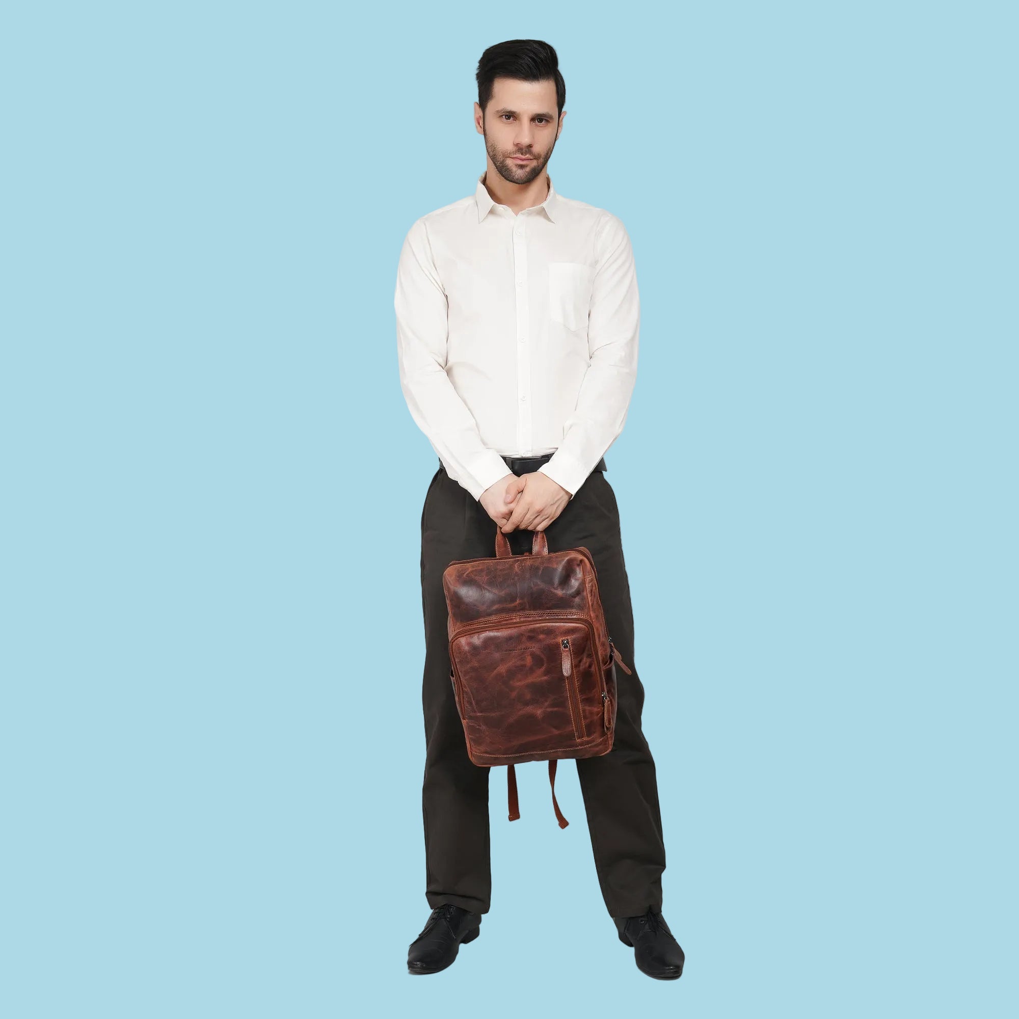 Minori Leather Oslo leather laptop backpack with 15.6-inch compartment, featuring sleek design and sturdy straps.
